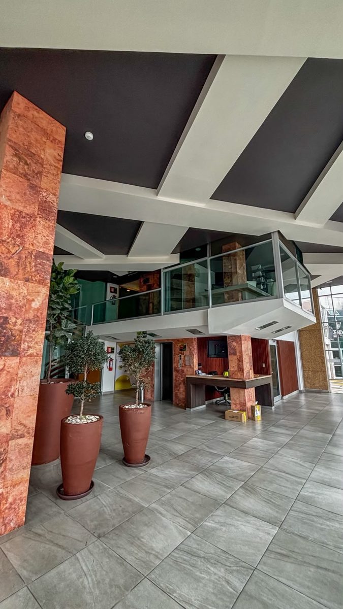 Lobby con mezzanine, elevadores y recepción del edificio